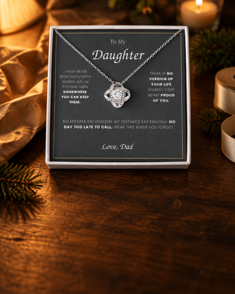 Love Knot necklace and message card in an open gift box on a walnut table, portrait format for mobile